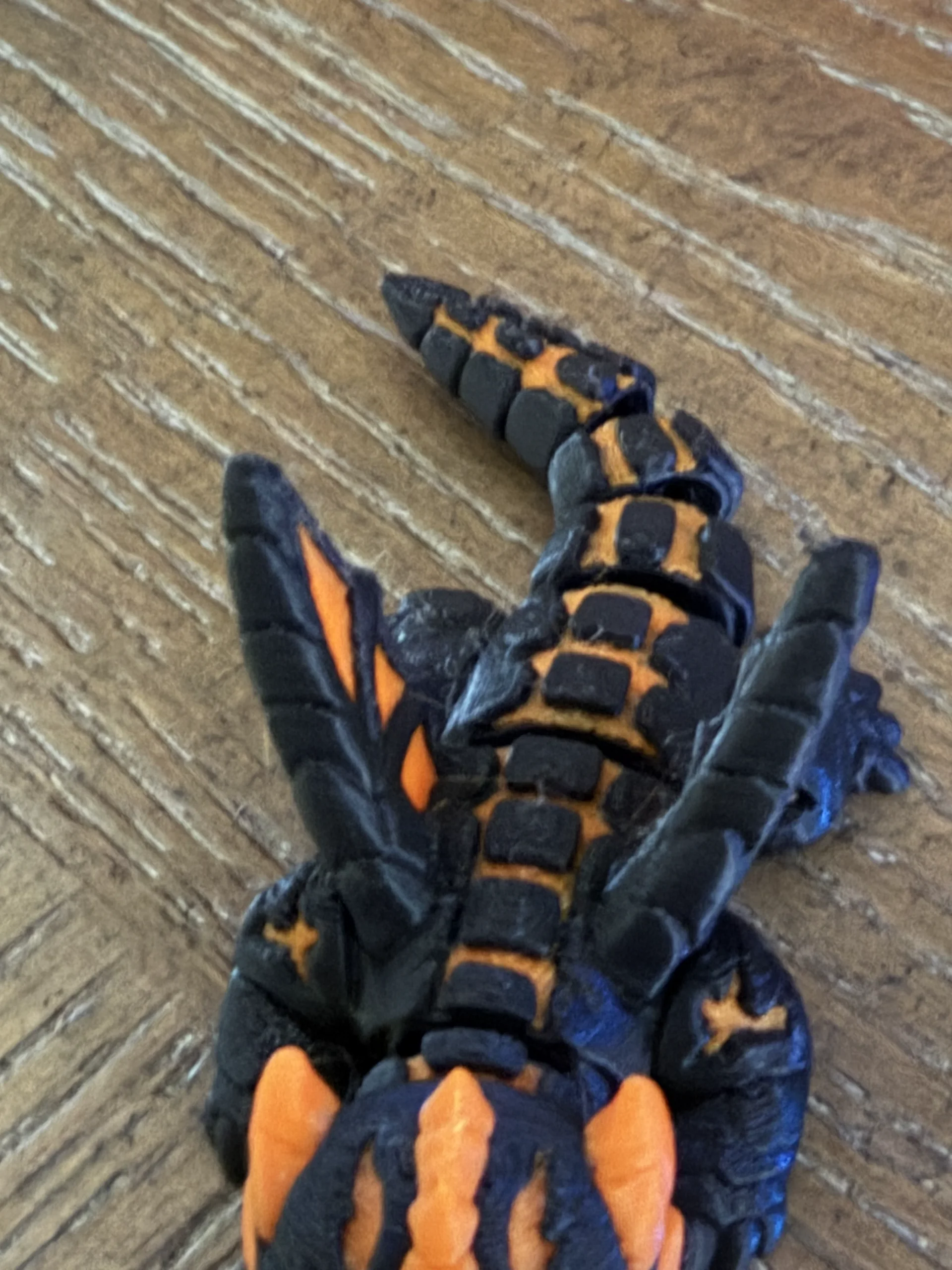 Second black and orange articulated dragon print showing minor stringing around the detailed features
