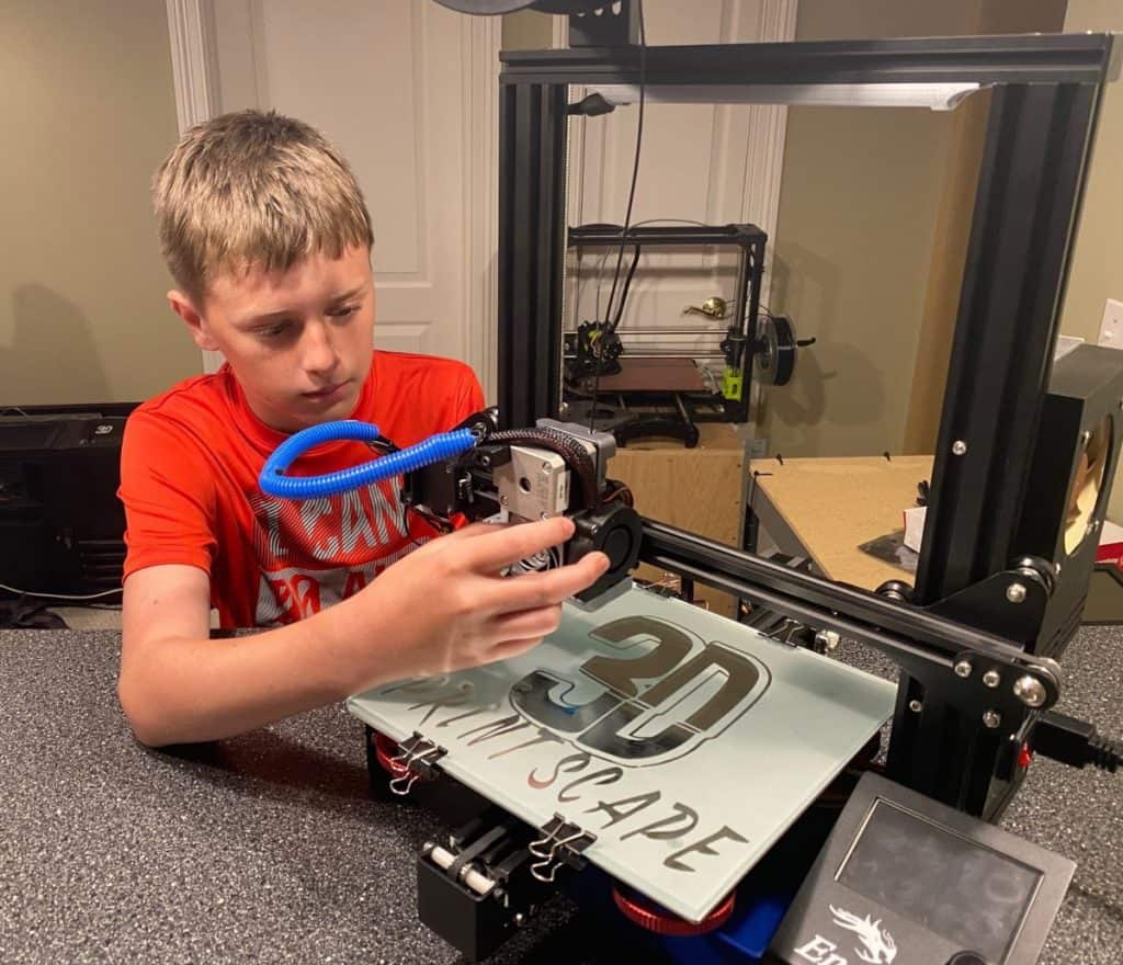 Kid working on 3d printer