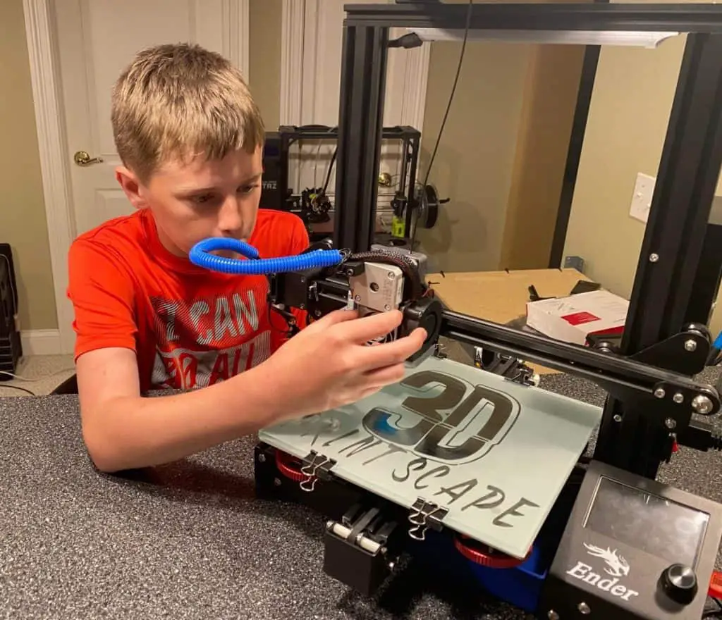 Kid working on 3d printer close up